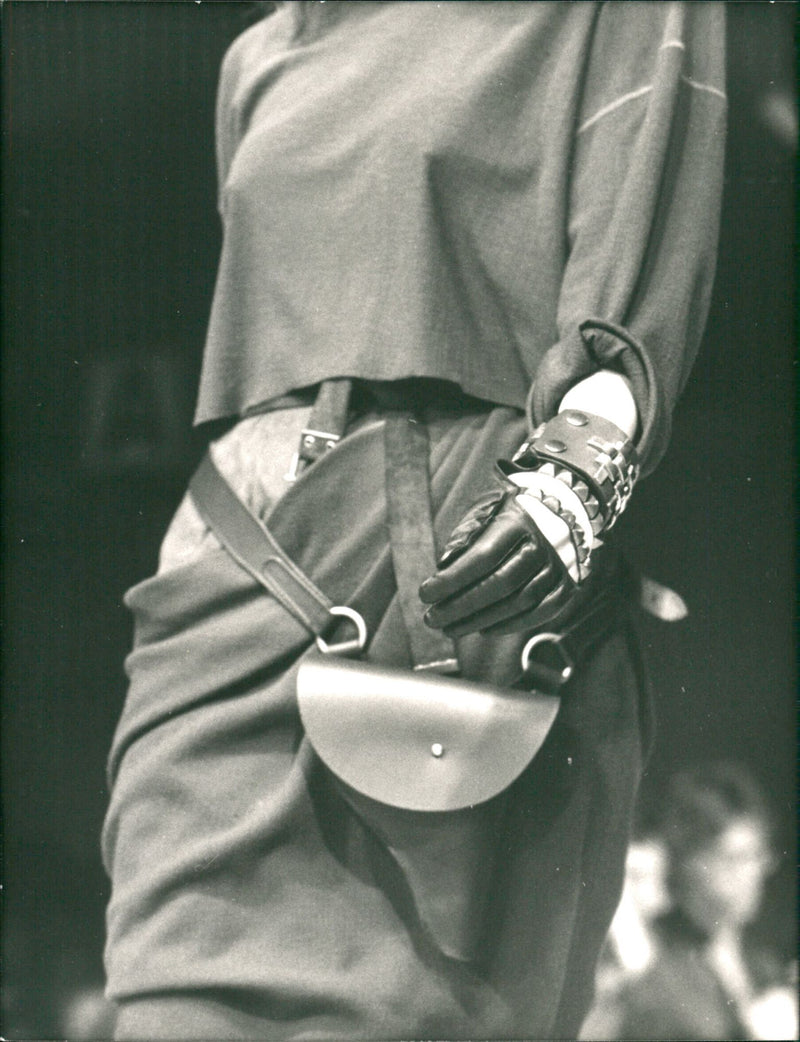 Jean Paul Gaultier show a body-guard bag, shaped like a gun. - Vintage Photograph