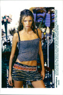 Spanish model Esther Canadas wears a top and mini skirt as part of Dolce Gabbana's autumn winter 1999-2000 collection at a Milan fashion show. - Vintage Photograph