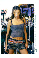 Spanish model Esther Canadas wears a top and mini skirt as part of Dolce Gabbana's autumn/winter 1999-2000 collection at a Milan fashion show. - Vintage Photograph