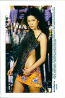 A model wears a top and mini skirt as part of Dolce Gabbana autumn/winter 1999-2000 collection at a Milan fashion show. - Vintage Photograph