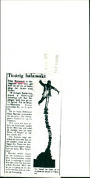 Timo Kärnekull, his writers Eino Hanski presented a sculpture, where the publisher balances on a book stack. - Vintage Photograph