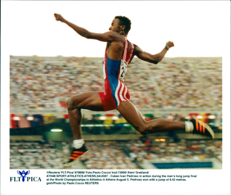 Cuban Ivan Pedroso in action in men's long jump final at the World Championships in Athletics in Athens. - Vintage Photograph