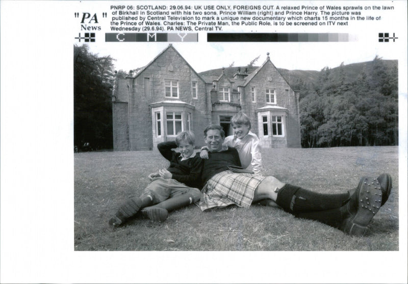 Prince of Wales sprawls on the lawn of Birkhall in Scotland with his two sons, Prince William and Prince Harry - Vintage Photograph