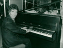 France's Minister of Culture Jack Lang plays the piano
at the International Music Fair - Vintage Photograph