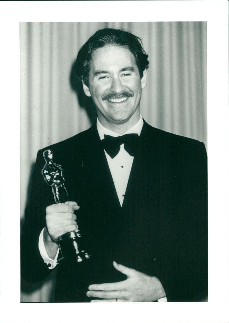 Actor Kevin Kline wins an Oscar for the movie "A Fish Called Wanda" - Vintage Photograph