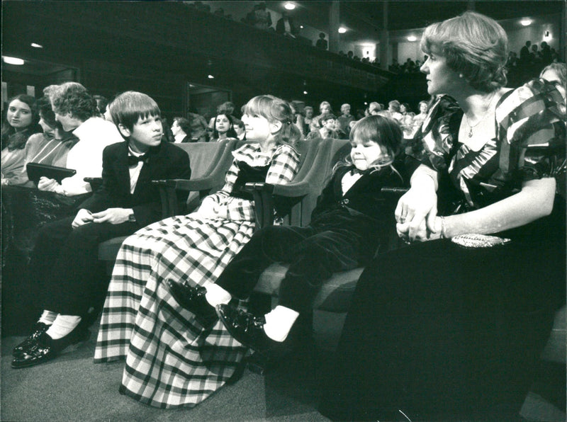 Klaus von Klitzing's children Andreas, Christine and Thomas and his wife Renate await the Nobel Prize ceremony in the concert hall. - Vintage Photograph