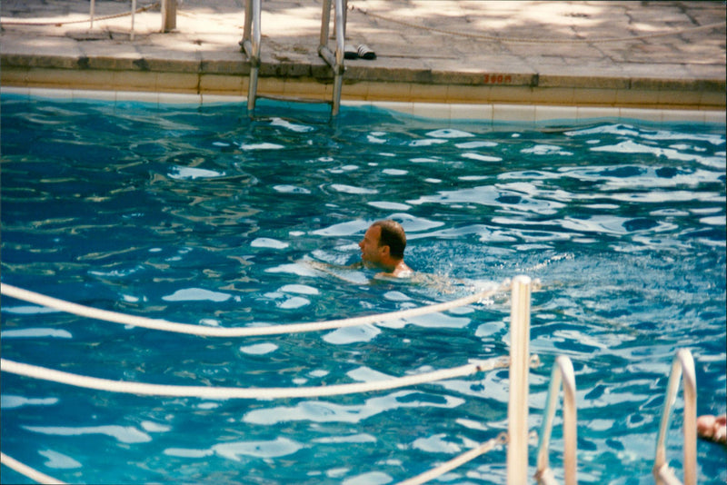 Sting swims in the hotel pool in Jerusalem - Vintage Photograph