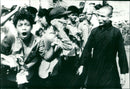 Buddhist monk tries to calm upset protesters - Vintage Photograph