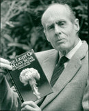 Group Captain Leonard Cheshire with his book "The Light of Many Suns" - Vintage Photograph