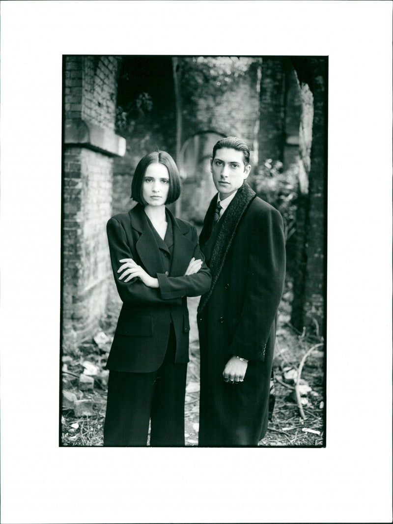 Man and woman wearing trench coats - Vintage Photograph