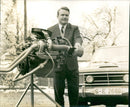 A Man Holding a Car Engine - Vintage Photograph