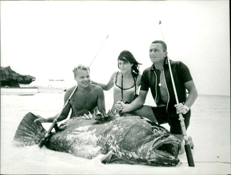 Fishermen pose on beach with huge catch - Vintage Photograph