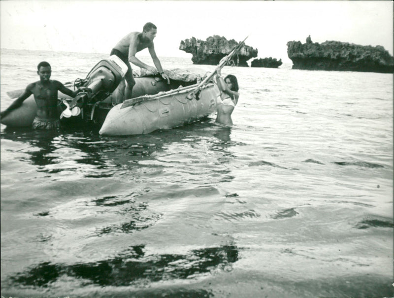 Harpoon fishing from a rubber dinghy boat - Vintage Photograph