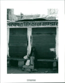 Elderly woman sitting on benach. India - Vintage Photograph