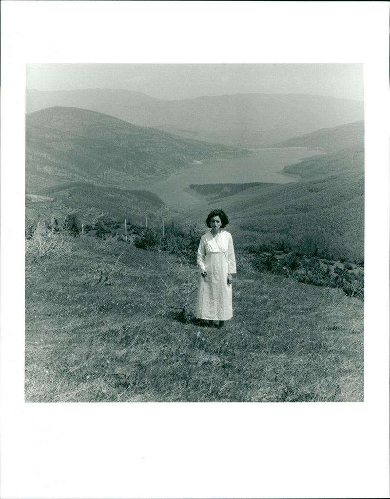 Woman in white standing in a picturesque landscape - Vintage Photograph