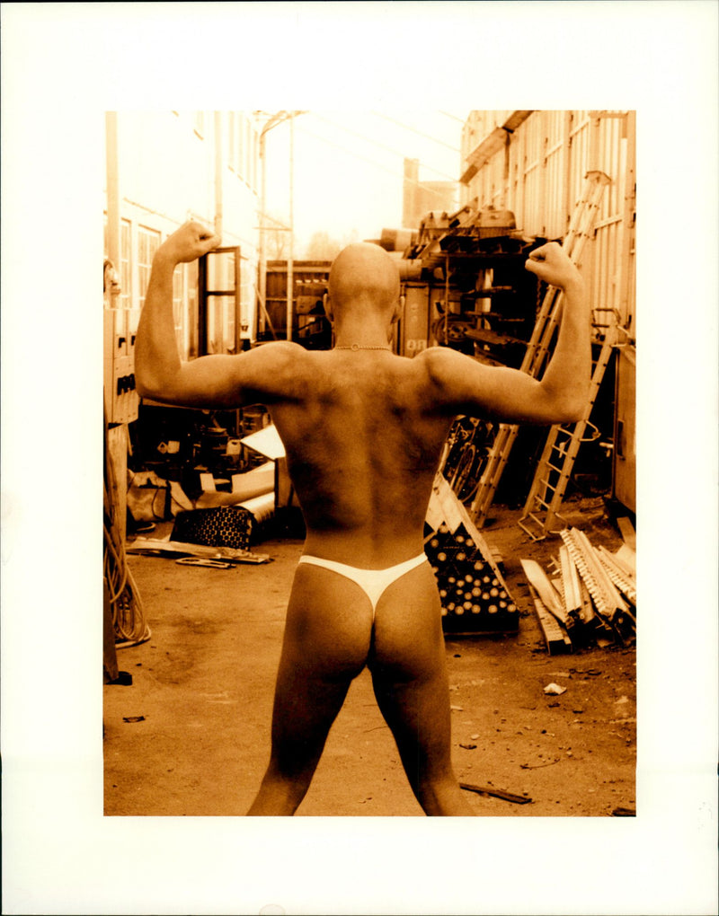 Man in thong tighten his muscles - Vintage Photograph