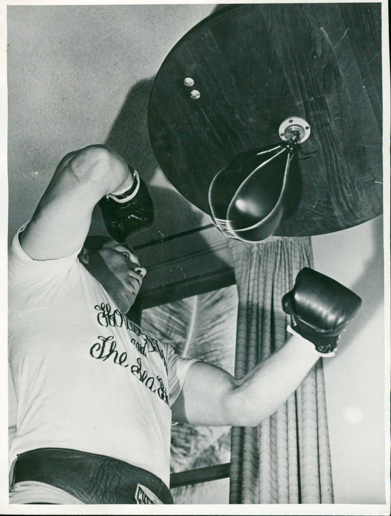 Ingemar Johansson softens himself with the pear ball before the match against Floyd Patterson - Vintage Photograph
