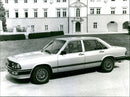 A view of Audi 200, parked next to a building - Vintage Photograph