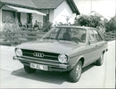 A view of Audi 80 LS parked next to a building - Vintage Photograph