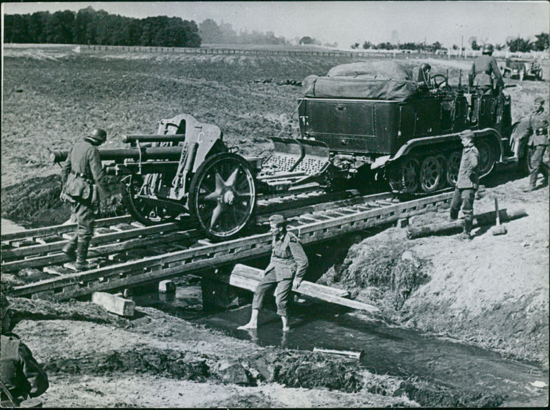 German artillery is brought across a bridge at - Vintage Photograph