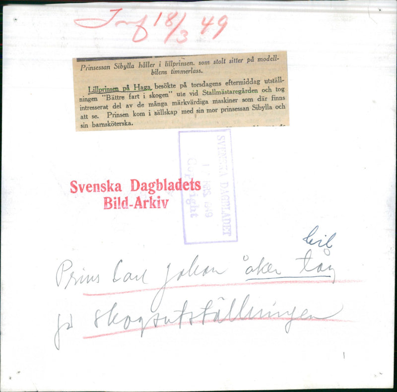 Princess Sibylla holds Prince Carl Gustaf who sits on the model car's lumber yard - Vintage Photograph