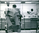 A barber cuts the hair of a US military officer - Vintage Photograph
