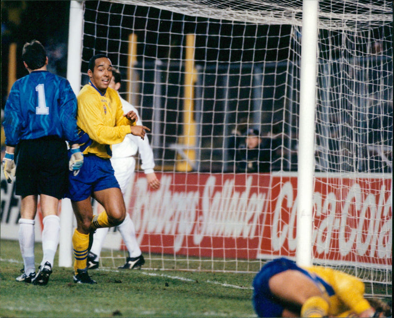 European Championship qualifier Sweden-Hungary. Martin Dahlin runs after his goal against an injured Tomas Brolin - Vintage Photograph