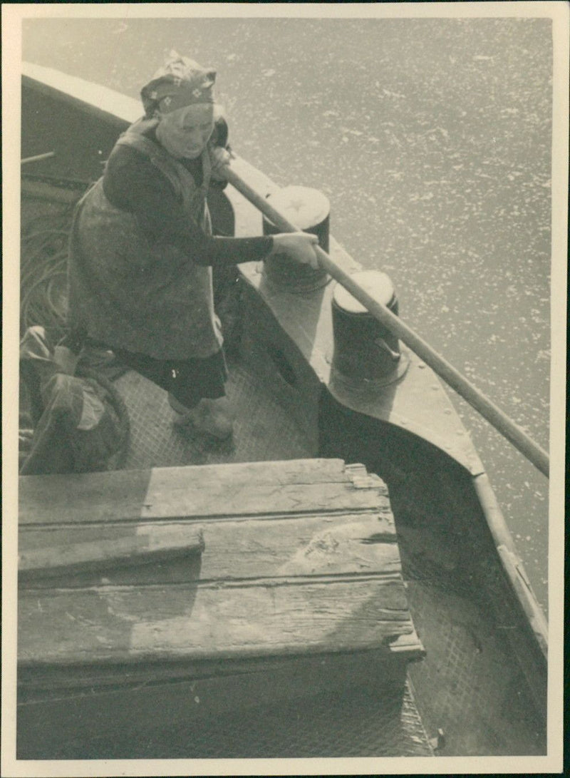 Woman cleaning on boat - Vintage Photograph