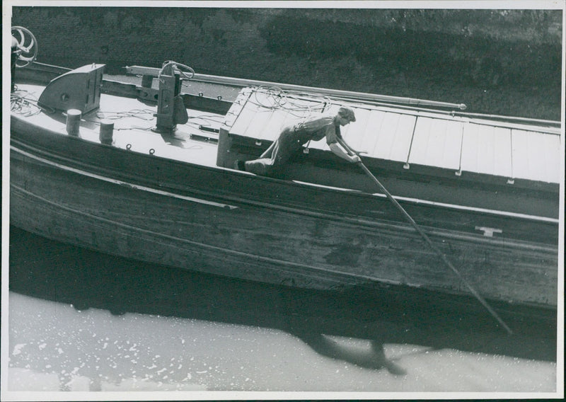 A shipper is pushing his boat away - Vintage Photograph