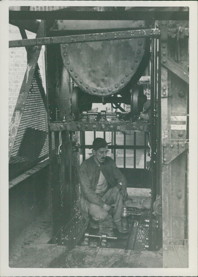 A mechanic doing some fixing on a boat engine - Vintage Photograph