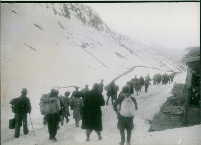 A group of people travelling in a snowy mountain - Vintage Photograph