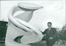 Man poses beside sculpture - Vintage Photograph