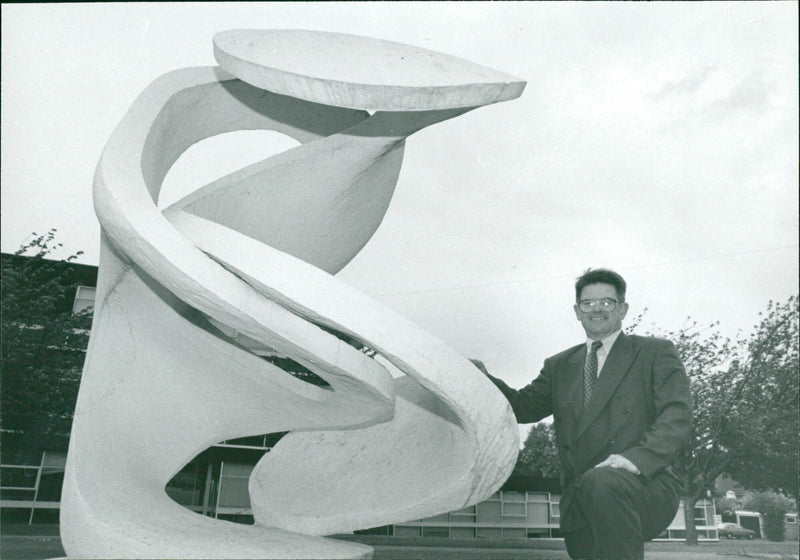 Man poses beside sculpture - Vintage Photograph