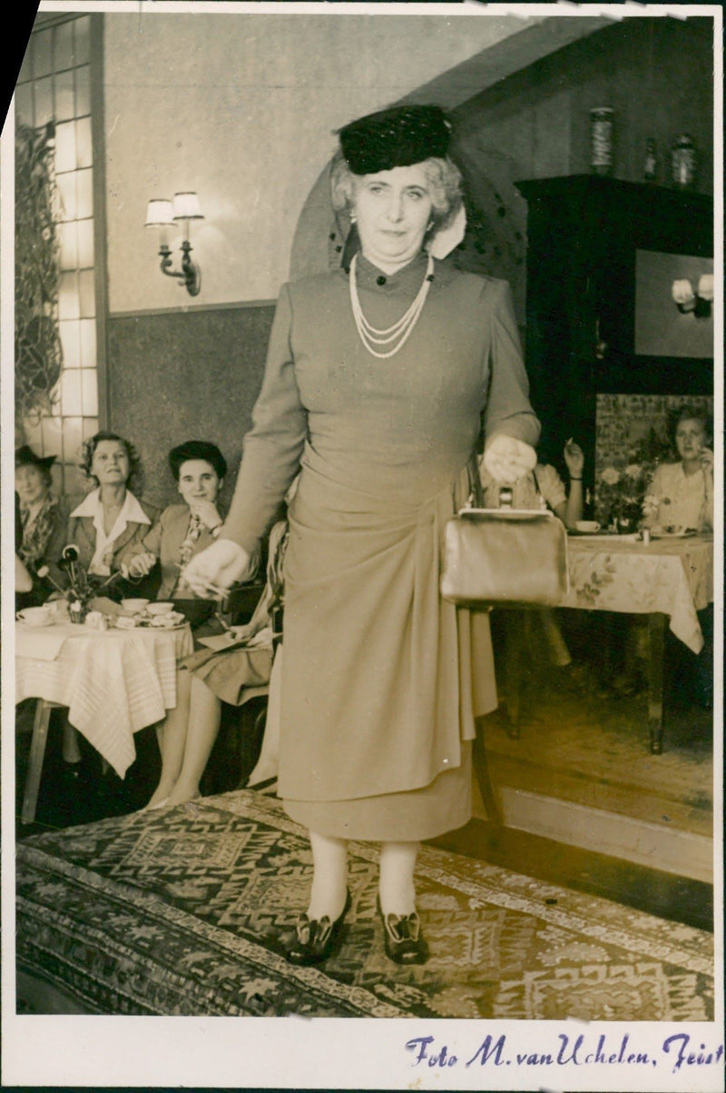 Elderly model posing with cloths on catwalk - Vintage Photograph