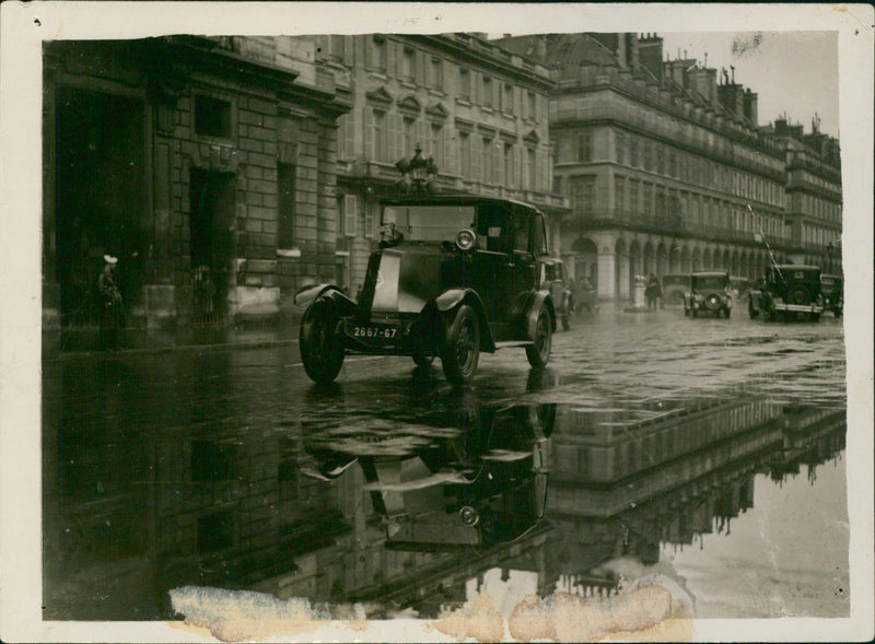Vintage car driving on a wet road - Vintage Photograph