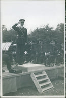 An army officer saluting on a podium - Vintage Photograph