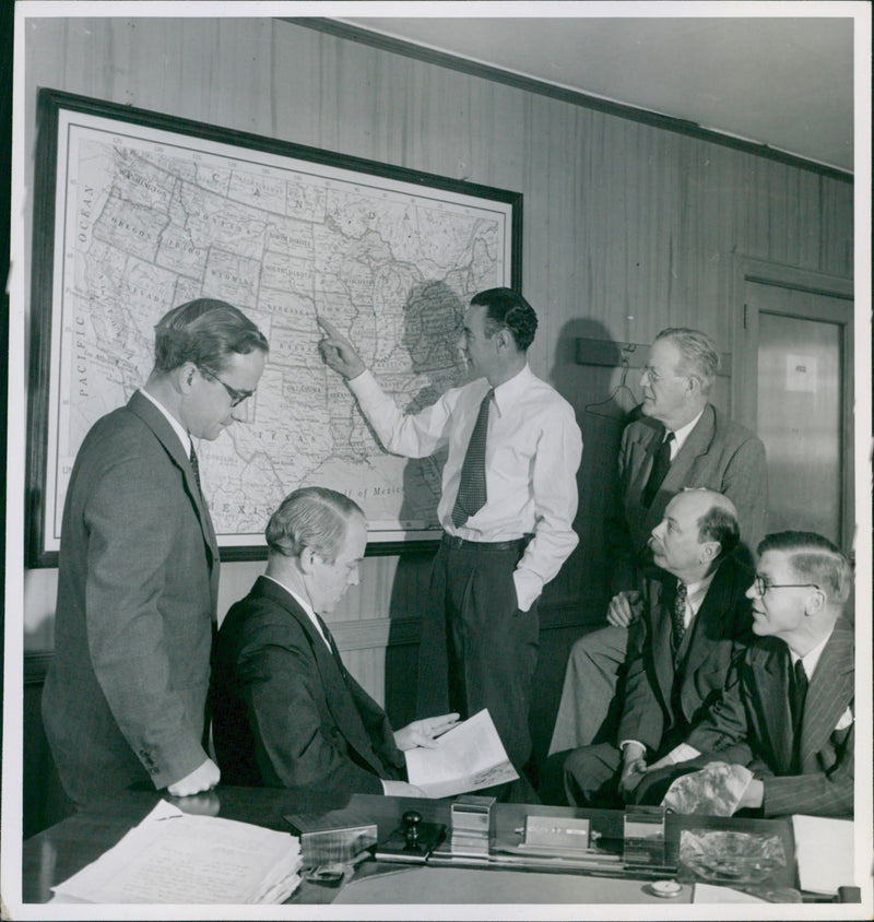 A group of men having a meeting over the US map - Vintage Photograph