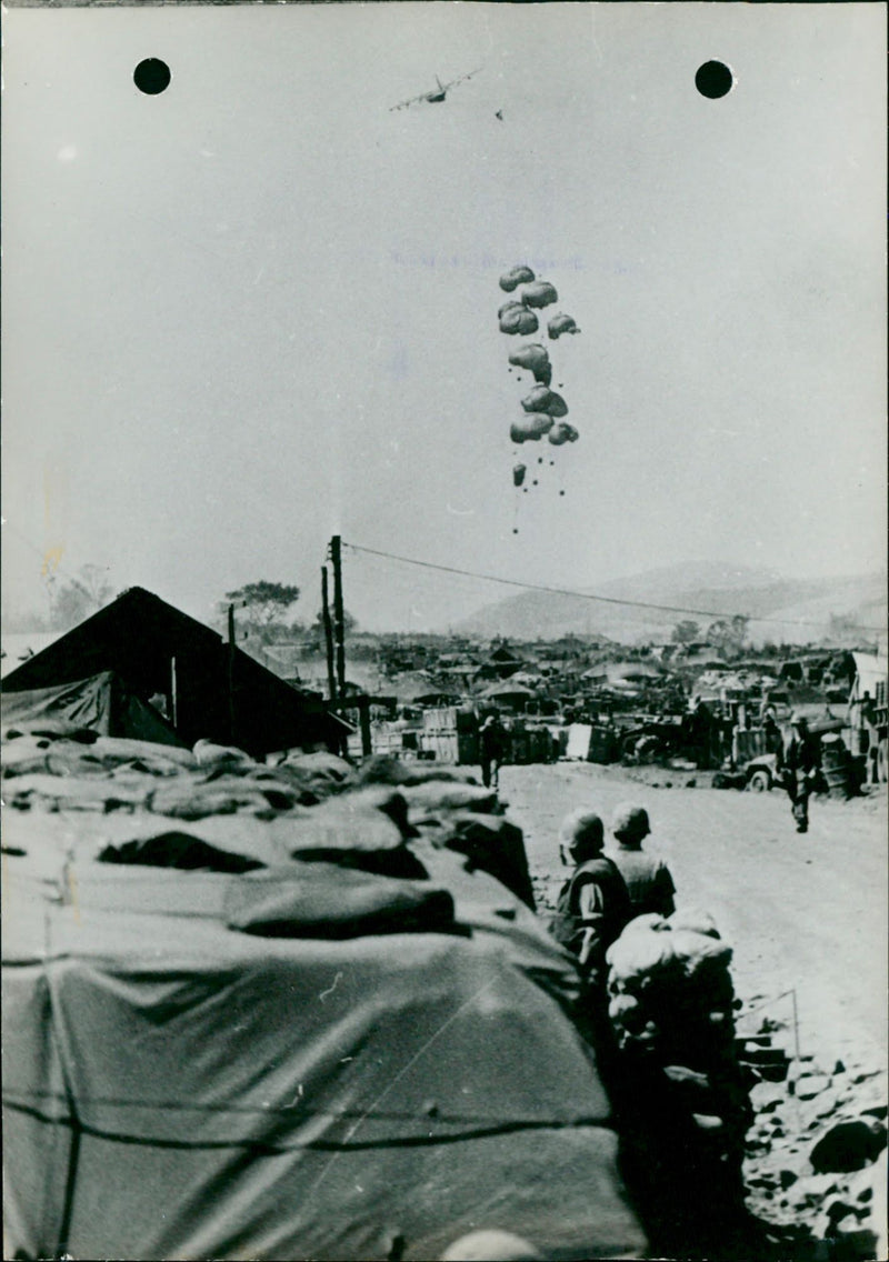 A C-130 airplane drops ammunition and food in Vietnam - Vintage Photograph