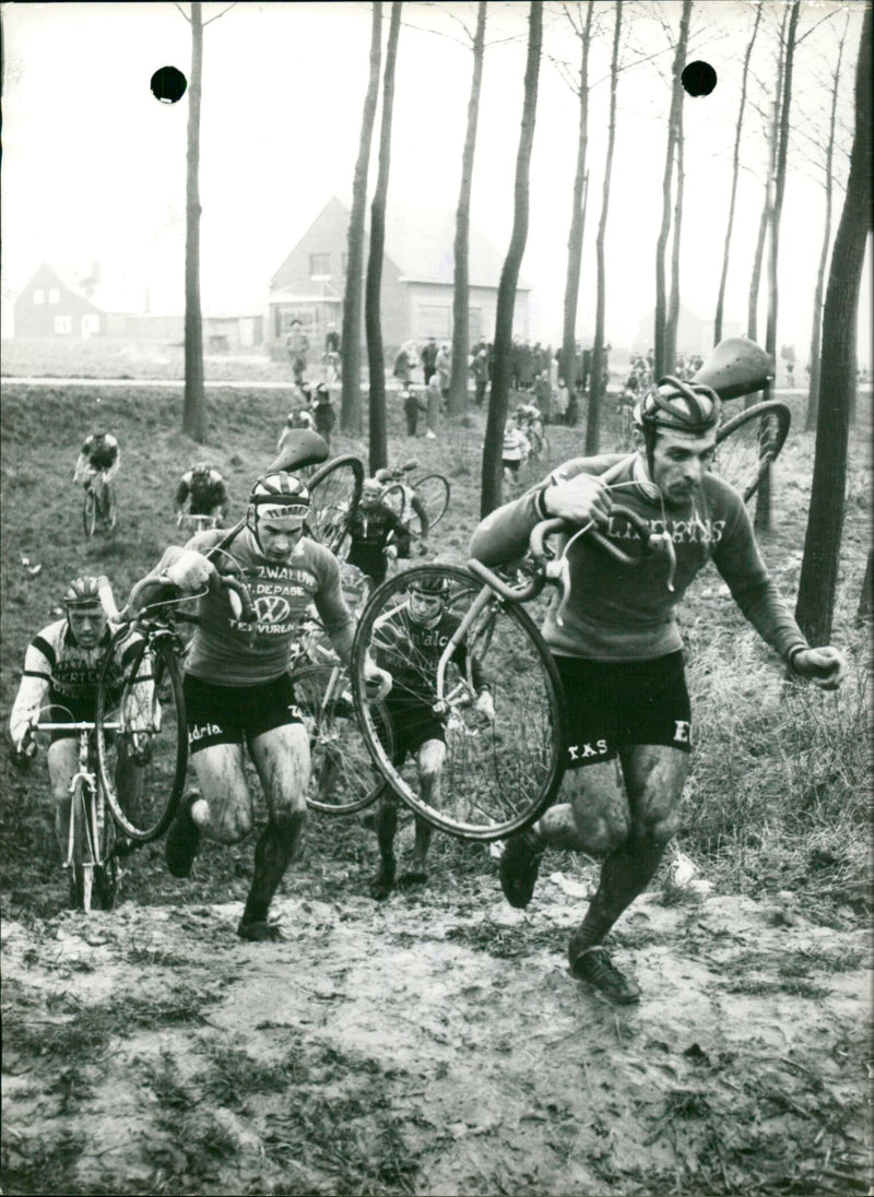 Firmin Van Kerrebroek is carring his bike through the mud - Vintage Photograph