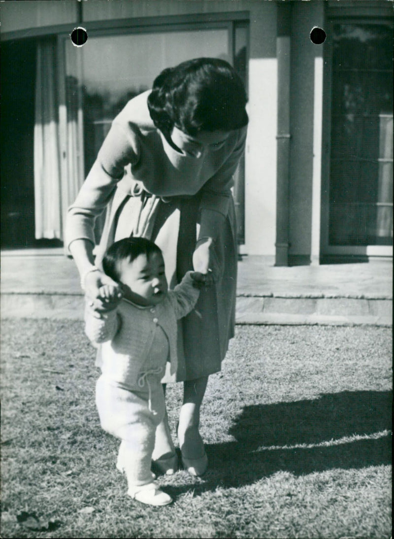 Princess Michiko is teaching Prince Hiro to walk - Vintage Photograph