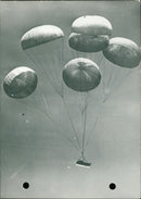 Six large parachutes guide a 2 and a half ton truck to the ground - Vintage Photograph