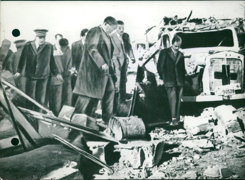 Tunisian officials inspect the rubble in the town of Sakiet - Vintage Photograph