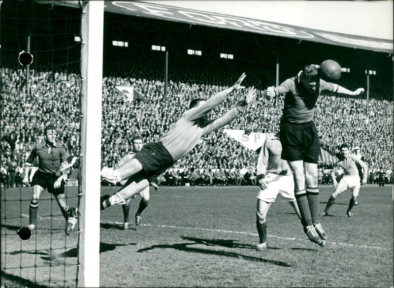 Belgian keeper plunging towards the ball, Marnette with a hearder. - Vintage Photograph