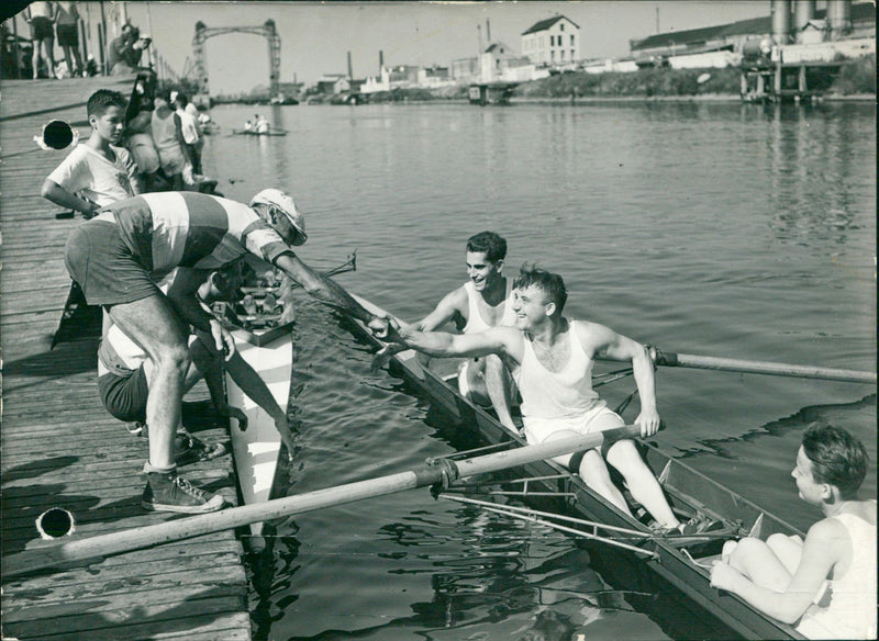 German (on the dock) congratulated by the American rowing team - Vintage Photograph