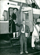 Mr and Mrs Viat descend from the helicopter - Vintage Photograph