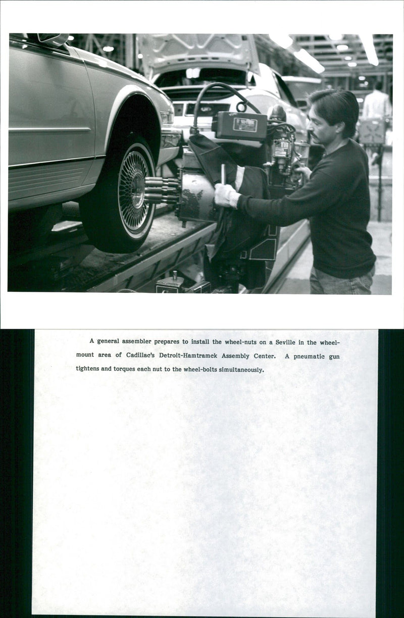 A general assembler prepares to install the wheel - nuts on a Seville in the whe - Vintage Photograph