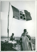 Locals in Africa standing under the flag of the Kingdom of Italy - Vintage Photograph