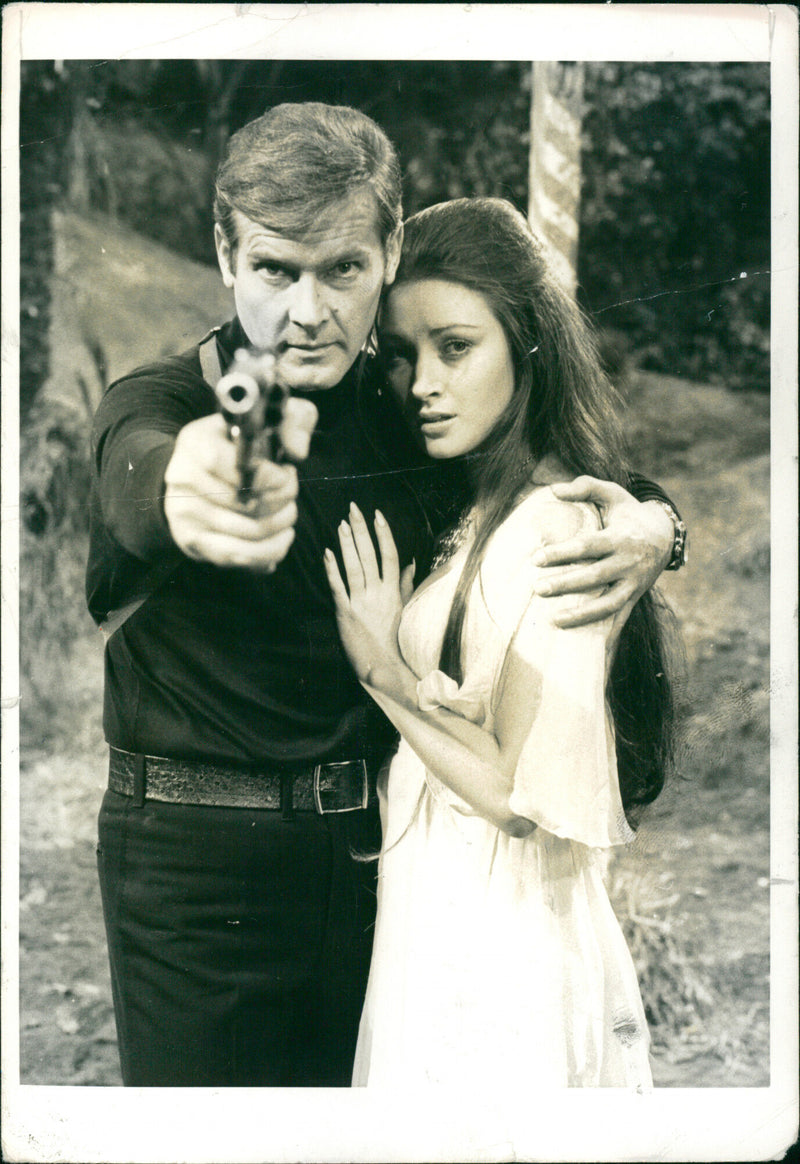 Jane Seymour and Roger Moore in the film "Live and Let Die." - Vintage Photograph