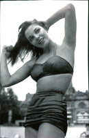 Actress Joan Collins poses in a black and white bikini in 1951. - Vintage Photograph