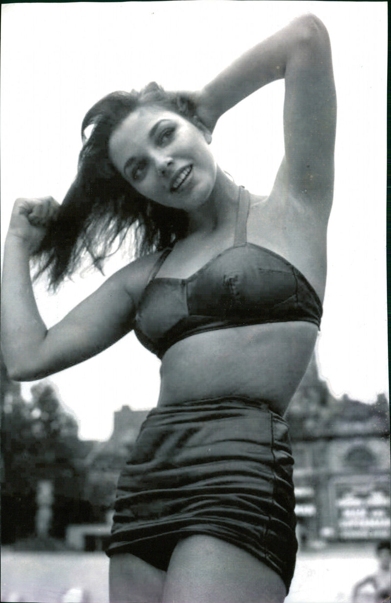 Actress Joan Collins poses in a black and white bikini in 1951. - Vintage Photograph
